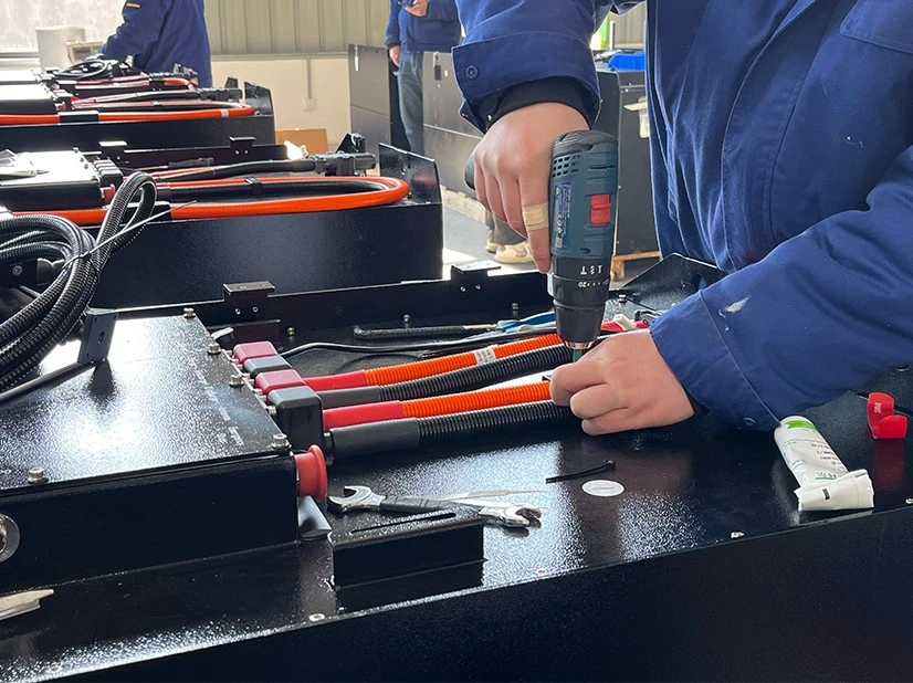 Compact LiFePO4 3 wheel forklift battery installed in a warehouse forklift battery compartment Compact LiFePO4 3 wheel forklift battery installed in a warehouse forklift battery compartment